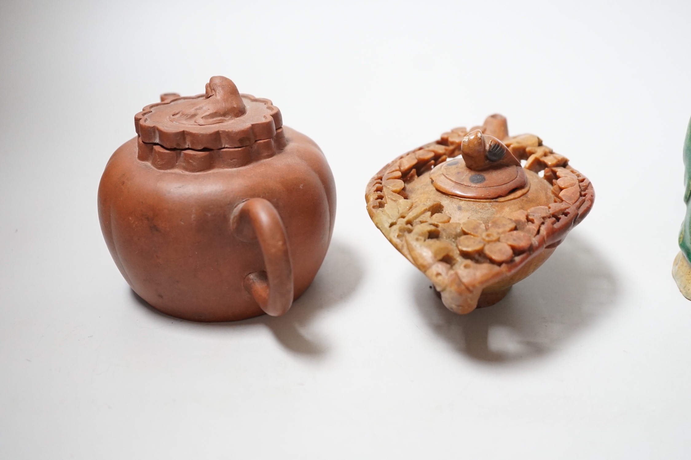 A Chinese carved soapstone pot, a terracotta teapot, and two earthenware figures, tallest figure 11cms high